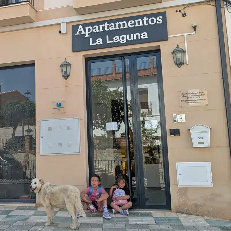 Qué ver en Fuente de Piedra: naturaleza, flamencos y planes curiosos 23 Niñas sentadas frente a Apartamentos La Laguna en Fuente de Piedra